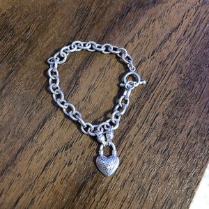 A sterling silver charm bracelet with diamonds
